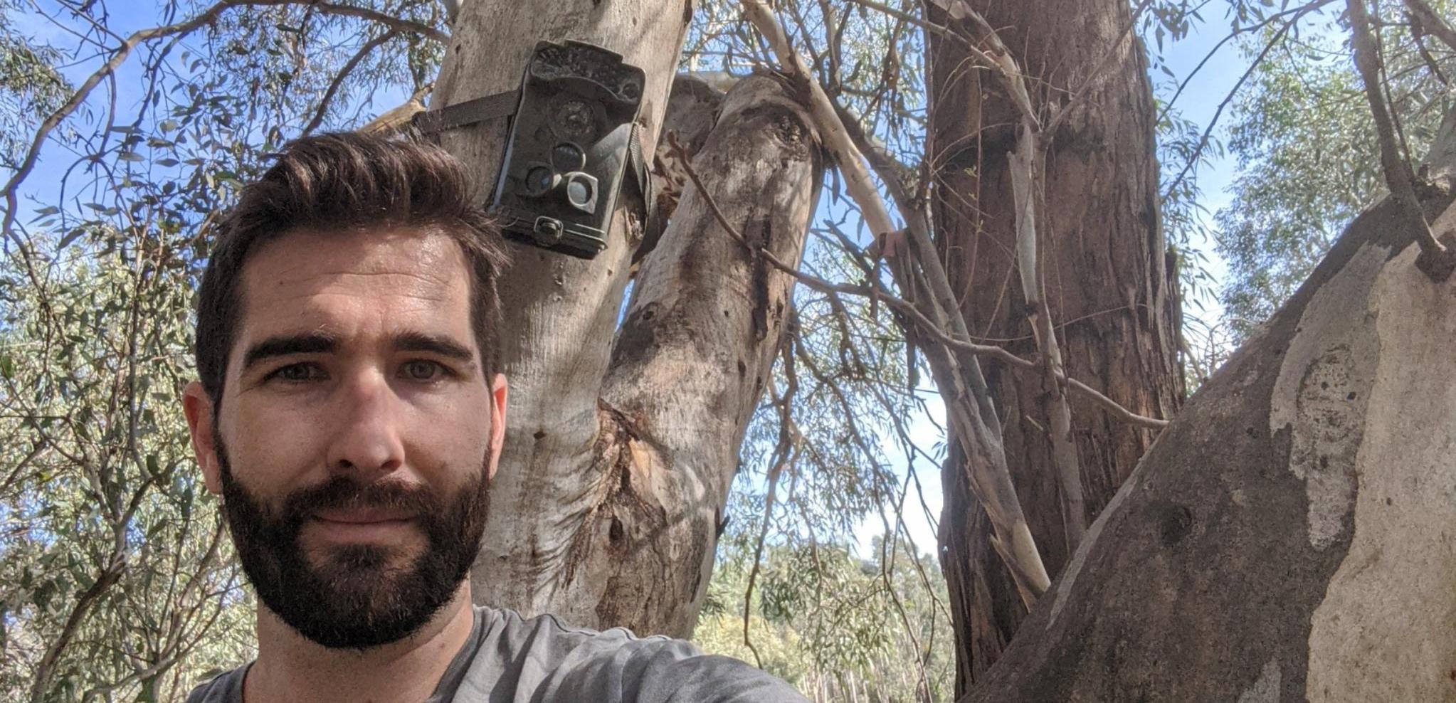 Albury Conservation Company's Dylan McWhinney with an installed motion-sensing camera, Thurgoona NSW (2020) 